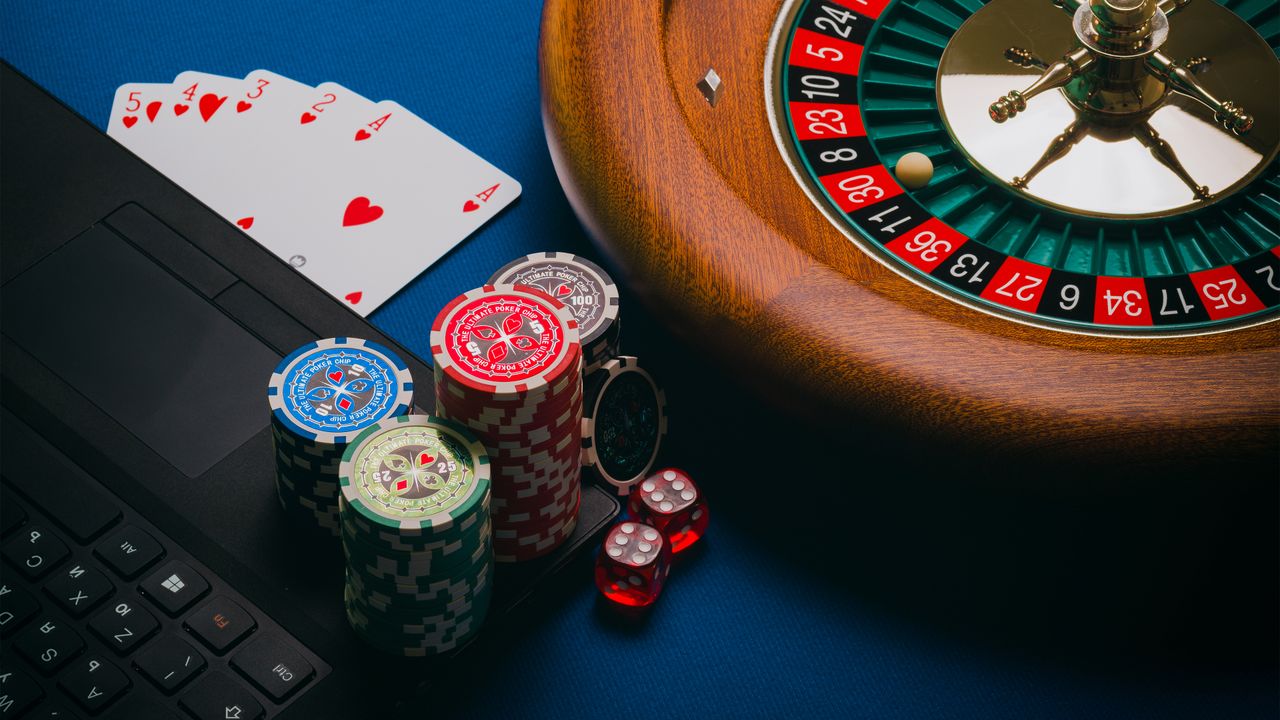 about-01 Close-up of a roulette table, poker chips, and playing cards depicting casino culture.