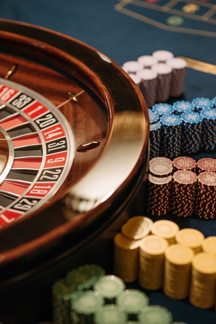 gallery-2 Close-up of a roulette table with colorful chips at a casino.
