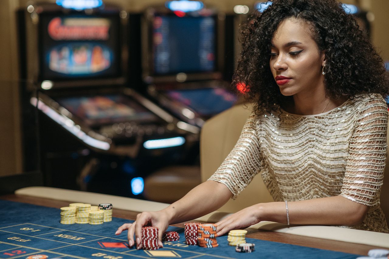 why-choose-us Elegant African American woman betting at casino gaming table with chips.